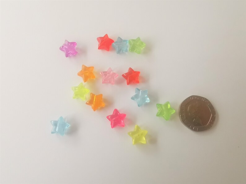 100 x coloured transparent plastic acrylic stars green pink red blue orange purple drilled yellow approximately 10.5mm x 11mm x 6mm