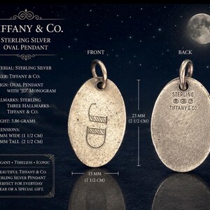 May include: A Tiffany & Co. sterling silver oval pendant featuring a JD monogram on the front and hallmarks on the back. The pendant measures 15 mm wide by 23 mm tall and weighs 3.86 grams. The front is labeled FRONT and the back is labeled BACK.