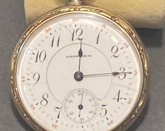 Reloj de bolsillo Hampden vintage de esfera abierta - 21 rubíes, ajustado.