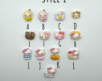 May include: Thirteen small, colourful resin charms, each with a different design. The charms include various food items and a popular cartoon character. The charms are labelled with letters A to M.