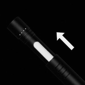 May include: A matte black cylindrical device featuring a white rectangular indicator window and a top section marked with four small white dots. A white arrow icon points diagonally upwards towards the right side of the device against a black background.