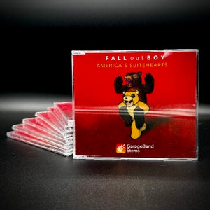 May include: A red CD case with a clear plastic cover. The front of the case features a cartoon image of two bears, one wearing a yellow bear costume. The text "FALL out BOY AMERICA'S SUITEHEARTS" is printed in white on the case. The text "GarageBand Stems" is printed in white on a red guitar icon.
