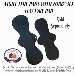 May include: Two black night-time pads with a textured surface. The pads are shaped with a wider base and a narrower top, featuring a snap closure. Text on the image reads "NIGHT-TIME PADS WITH ZORB® 3D STAY DRY PAD" and "Sold Separately".