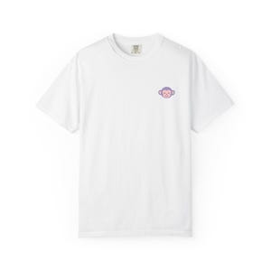 May include: A white short-sleeved t-shirt featuring a small, centered graphic on the upper left chest area. The graphic depicts a smiling monkey face with light purple ears and a soft pink face, rendered in a simple, clean, and minimalist line art style.
