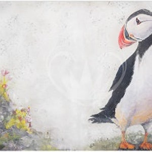 May include: A white and black puffin with a red beak and orange feet stands on a rocky cliff with green and yellow plants. The background is a light gray.