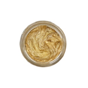 May include: A small glass jar filled with a swirl of gold metallic paint.