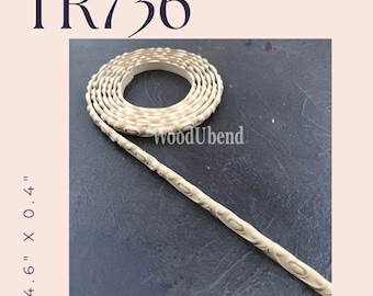 May include: A close-up of a beige wood trim molding with a decorative pattern. The molding is 8.6 inches long and 0.4 inches wide. The trim is rolled up in a coil.