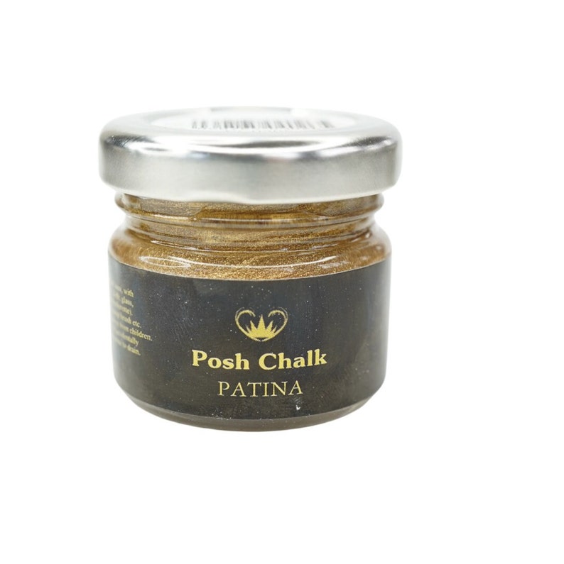 May include: A small glass jar with a silver lid containing gold-coloured paint. The label reads "Posh Chalk PATINA".