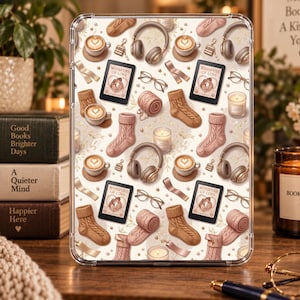 May include: A clear tablet case featuring a repeating pattern of cozy items including brown knit socks, beige headphones, lattes with heart foam art, eyeglasses, rolled blankets, candles, and e-readers displaying the text Whispers of Love.