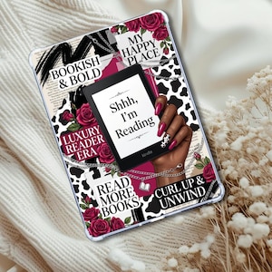 May include: A clear tablet case with a black and white cow print design, red roses, and text that reads "Bookish & Bold", "Luxury Reader Era", "Read More Books", "Curl Up & Unwind", and "My Happy Place". A Kindle e-reader displays "Shhh, I'm Reading".
