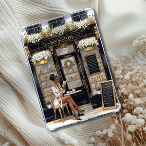 May include: Clear tablet case featuring an illustration of a woman reading outside a bookstore. The bookstore has a black and gold facade with white flowers and the word "BOOKSTORE" above the door. The woman is wearing a white and gold outfit.