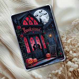 May include: Clear tablet case with a gothic bookstore design. The image shows a full moon, bats, and carved pumpkins. The word "Bookstore" is above the entrance. Red roses and vines decorate the building.