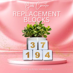 May include: White replacement blocks with gold numbers 37, 194, and a small potted plant. The text "Book Counter Replacement Blocks" is at the top. The bottom text reads "POPPY & ROSS HANDMADE". The background is pink.