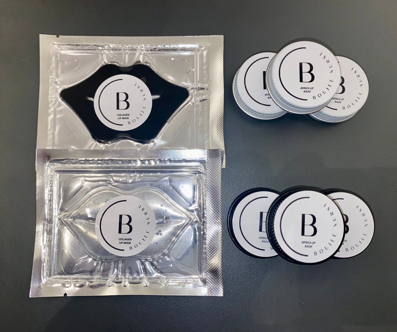 May include: Two silver pouches containing black lip masks with the text "ISHTA BOUIUIK COLLAGEN LIP MASK" and the letter "B" in a circle.  Four black containers with the text "ISHTA BOUIUIK ARNICA LIP BALM" and the letter "B" in a circle.