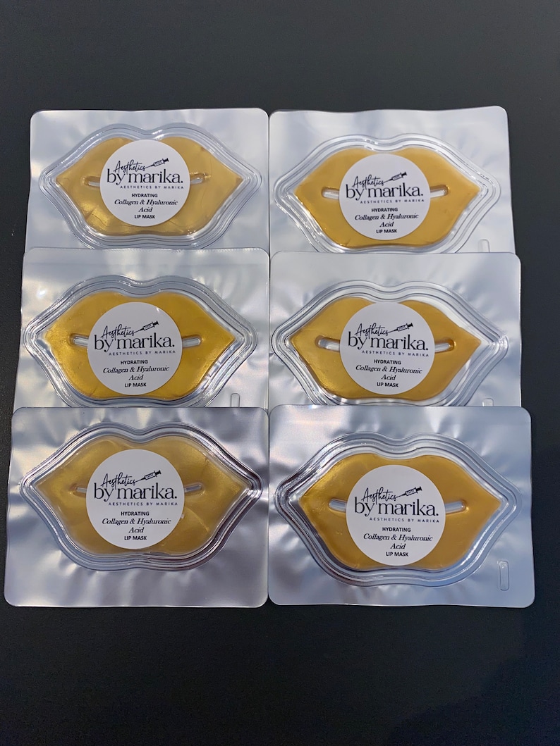 May include: Six individual packages of gold lip masks. Each package contains a lip-shaped mask with the text "Aesthetics by Marika. Hydrating Collagen & Hyaluronic Acid Lip Mask" printed on it.