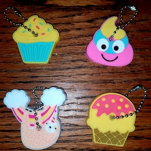 Key Covers in Blue Cupcake, Unicorn Poop Emoji, Rainbow Unicorn Sloth, & Strawberry Ice Cream Cone