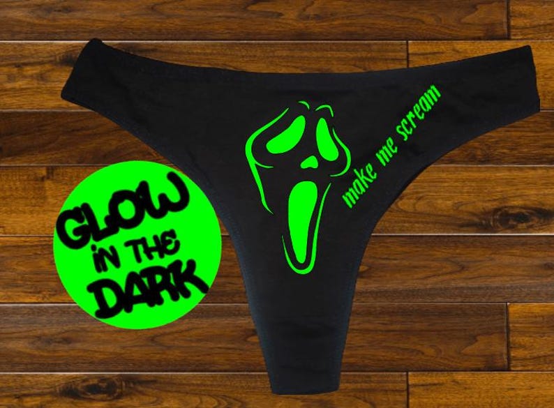 May include: Black underwear with a green glow-in-the-dark graphic of a screaming face and the text "Make me scream".