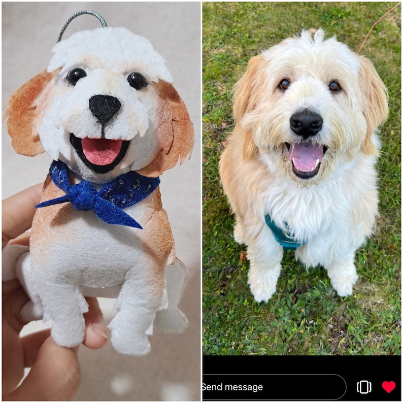 May include: A plush toy dog with brown and white fur, wearing a blue bandana. The toy is sitting on a hand. The image also shows a real dog with brown and white fur, sitting on green grass.