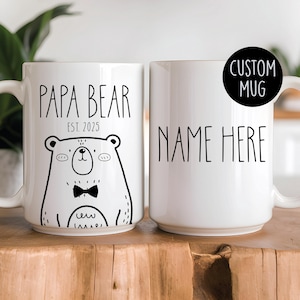 Custom ceramic mug featuring Papa Bear text with a cute bear illustration, personalized with a name and established year. Available in 11oz or 15oz sizes, ideal for first Father’s Day or pregnancy announcements.