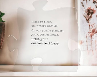 May include: A clear acrylic puzzle piece with the text "Piece by piece, your story unfolds, On our puzzle plaques, your journey holds. Print your custom text here."