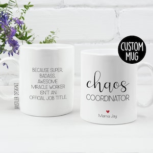 May include: Two white ceramic mugs with black text. The mug on the left says "Because super, badass, awesome miracle worker isn't an official job title." The mug on the right says "chaos coordinator" with a small red heart and the text "Mama Jay" below. The text "CUSTOM MUG" is in a black circle in the upper right corner of the image.