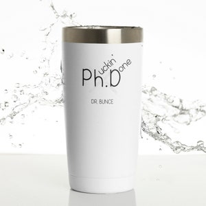 May include: White insulated tumbler with a silver rim. The tumbler features the text "Ph.D fuckin' done" and "DR. BUNCE" in black. The tumbler is designed to keep beverages hot or cold.