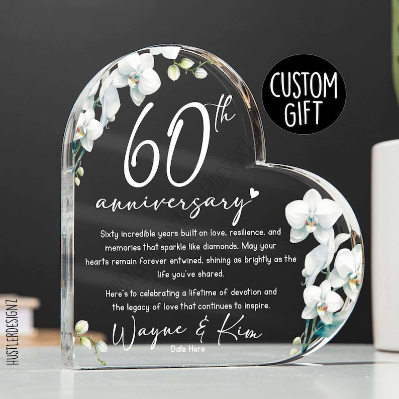 Heart-shaped acrylic plaque with white orchid design and custom engraved text celebrating 60 years of marriage.
