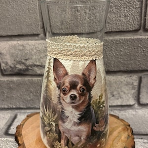 May include: A trio of cream-glazed ceramic mugs, each adorned with a hand-painted floral pattern in blue, green, and yellow hues. The mugs have a classic, rounded form and a practical handle. Ideal for enjoying tea or coffee.