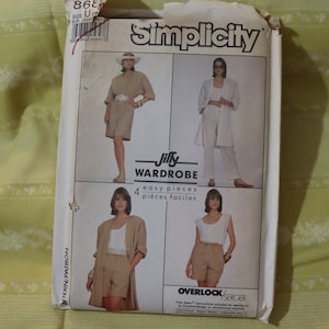 May include: Simplicity sewing pattern for a Jiffy Wardrobe with four easy pieces. The pattern shows four different outfits, including a white top with shorts, a white top with pants, a white top with a long cardigan, and a white top with a long dress. The pattern is labeled "Overlock/Serger" and includes instructions for sewing on an Overlock/Serger or conventional machine.