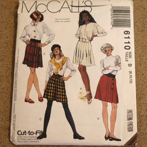 May include: A McCall's 6110 sewing pattern envelope for skirts in size B (8, 10, 12). The front features illustrations of four skirt styles, including plaid and solid designs, paired with various tops. The text includes the brand name, pattern number, size, and the phrase Cut-to-Fit.
