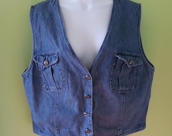 May include: A blue denim vest with a V-neck, button closure, and two flap pockets on the front.