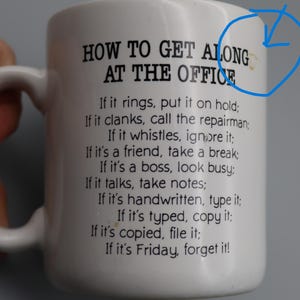 May include: White ceramic mug with a black printed list of office etiquette rules. The mug has a handle and the text reads "HOW TO GET ALONG AT THE OFFICE" followed by humorous instructions. A perfect gift for coworkers.