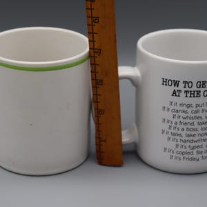 May include: A set of three ceramic mugs with a speckled, matte finish. Each mug features a different color: light blue, cream, and gray. The mugs have a simple, modern design and a comfortable handle.