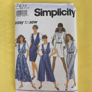 May include: A Simplicity 7877 sewing pattern envelope for size AA (PT-MD) featuring illustrations of five different outfits including dresses, a jumpsuit, and a skirt set, all styled with white tops and belts, labelled easy to sew.