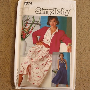 May include: A vintage Simplicity sewing pattern envelope featuring a woman in a red jacket and floral print dress. The envelope includes a smaller image of a woman in a blue dress. The word "Simplicity" is prominently displayed.