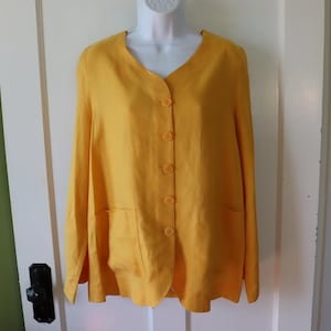May include: A bright yellow linen blazer with a V-neckline and long sleeves. The blazer features a button-down front, two front pockets, and matching yellow buttons. The garment is displayed on a white mannequin.