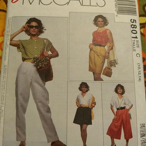 May include: A vintage McCall's sewing pattern envelope with fashion illustrations. The envelope shows images of outfits, including trousers, skirts, and tops. The text "Easy McCall's" and "Woman's Day Collection" are visible.