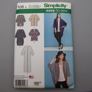 May include: A Simplicity sewing pattern envelope, number 1108, for an easy-to-sew open-front cardigan. The package displays illustrations of various cardigan styles, including floral and geometric prints, and photographs of the garment in use.