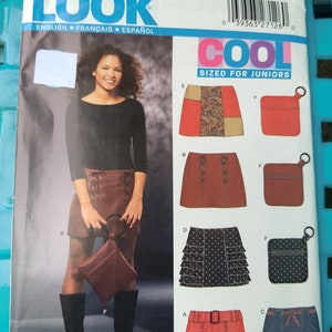 May include: A sewing pattern for a skirt, featuring five different skirt styles. The pattern is for sizes 3/4-13/14 and is labeled "Cool Sized for Juniors".