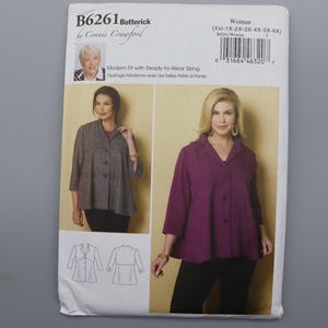 May include: A Butterick B6261 sewing pattern envelope featuring Connie Crawford. The package displays two jacket variations: one in grey and one in purple, both with three-quarter sleeves, a collar, and a button-front closure. Includes line drawings.