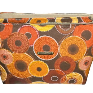 May include: A brown and orange zippered makeup bag with a circular pattern. The bag has a brown leather tag with the text "LulaRoe" on it.