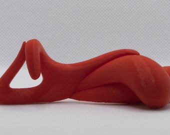 May include: A red 3D printed abstract sculpture with a smooth, rounded surface. The sculpture is shaped like a stylized human figure in a reclining pose.