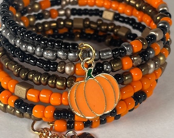 Pumpkin Charm Memory wire wrap 6 stack Bracelet with orange, purple, black and bronze seed beads in halloween theme color.