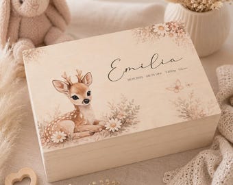 May include: A rectangular wooden keepsake box featuring a printed illustration of a fawn resting among flowers. The lid is personalized with the name Emilia, the date 26.01.2025, the time 06:34 Uhr, and the birth stats 3650g and 55cm.