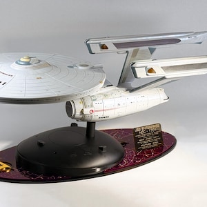 May include: A set of three ceramic nesting bowls in shades of blue, green, and white. The bowls feature a speckled glaze and a simple, modern design. The largest bowl is approximately 6 inches in diameter.