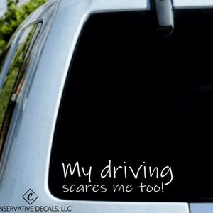 May include: A white vinyl decal sticker for a car window. The sticker says "My driving scares me too!"