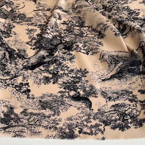 May include: Beige fabric with a black and white toile pattern featuring trees and foliage.
