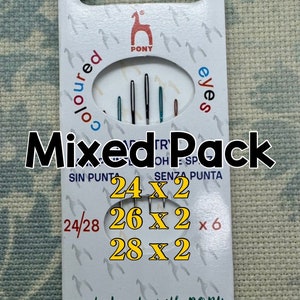 May include: A pack of Pony brand "Coloured Eyes" sewing needles. The package features a variety of needle sizes, with the text "Mixed Pack" and the sizes 24x2, 26x2, and 28x2. The package is white with a horse logo.
