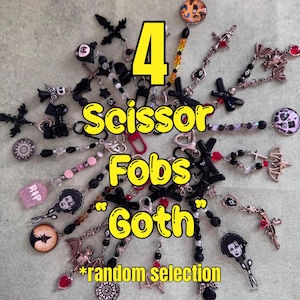 May include: A collection of goth-themed scissor fobs with various charms, including crosses, bats, and cameo portraits. The image features the text "4 Scissor Fobs Goth *random selection" in yellow. The fobs are black, silver, and red.