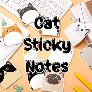 May include: Cat-shaped sticky notes in various colors and designs, including orange tabby, gray, and black and white cats. The notes are arranged on a light orange surface with a keyboard and pens.